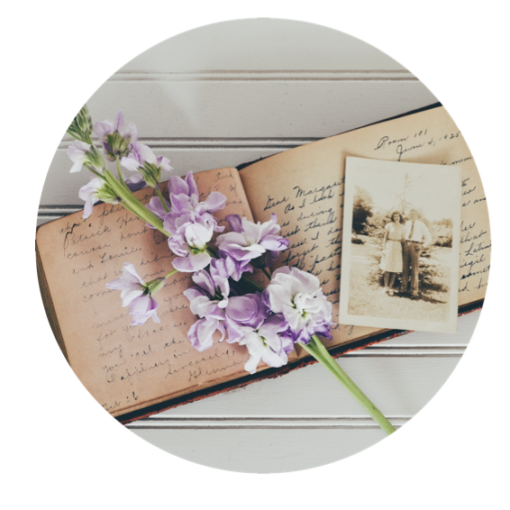 Diary and old photograph with a lilac flower laid on top