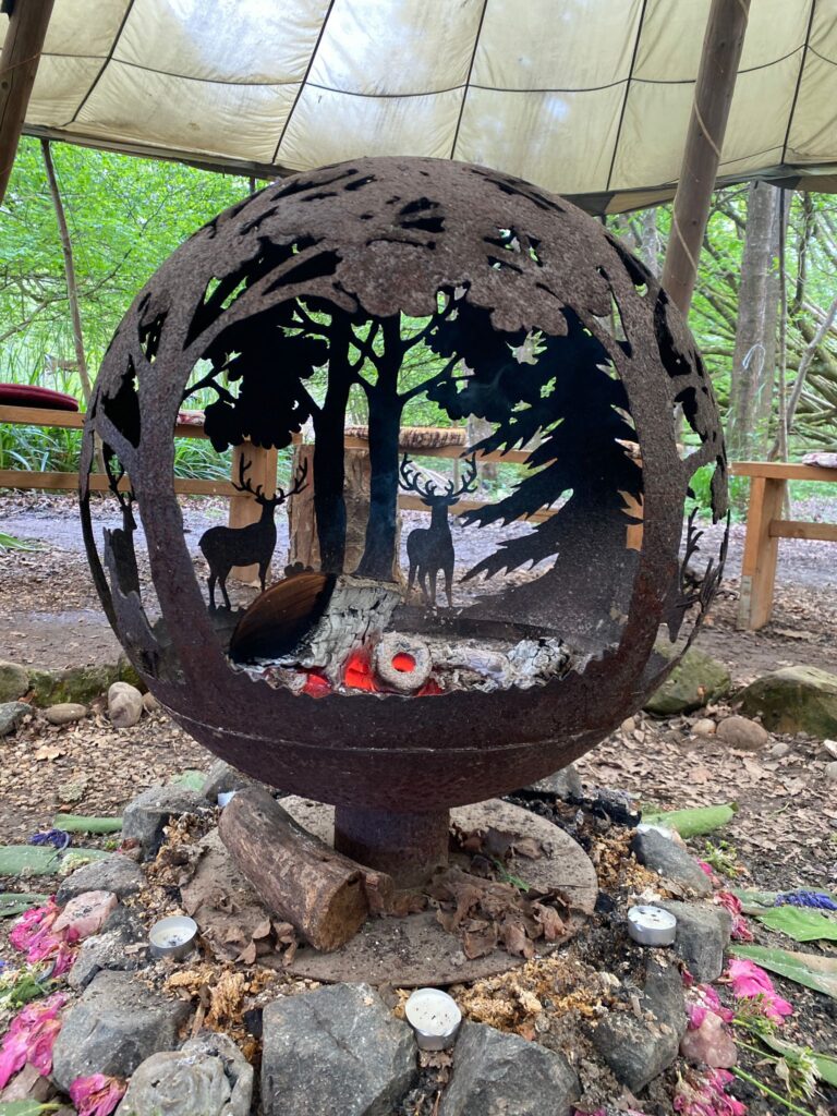 Fire Pit at the Enchanted Glade. Iron structure with forest design of fir trees and stags.